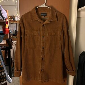 Brown corduroy button up jacket with chest pockets.
